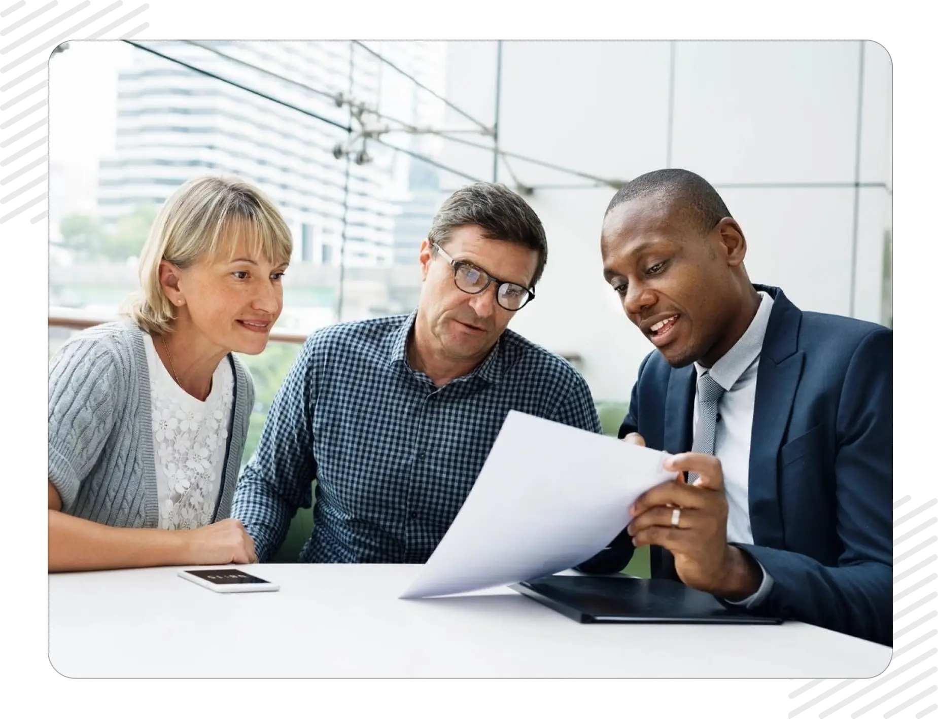 Three people are looking at a paper.